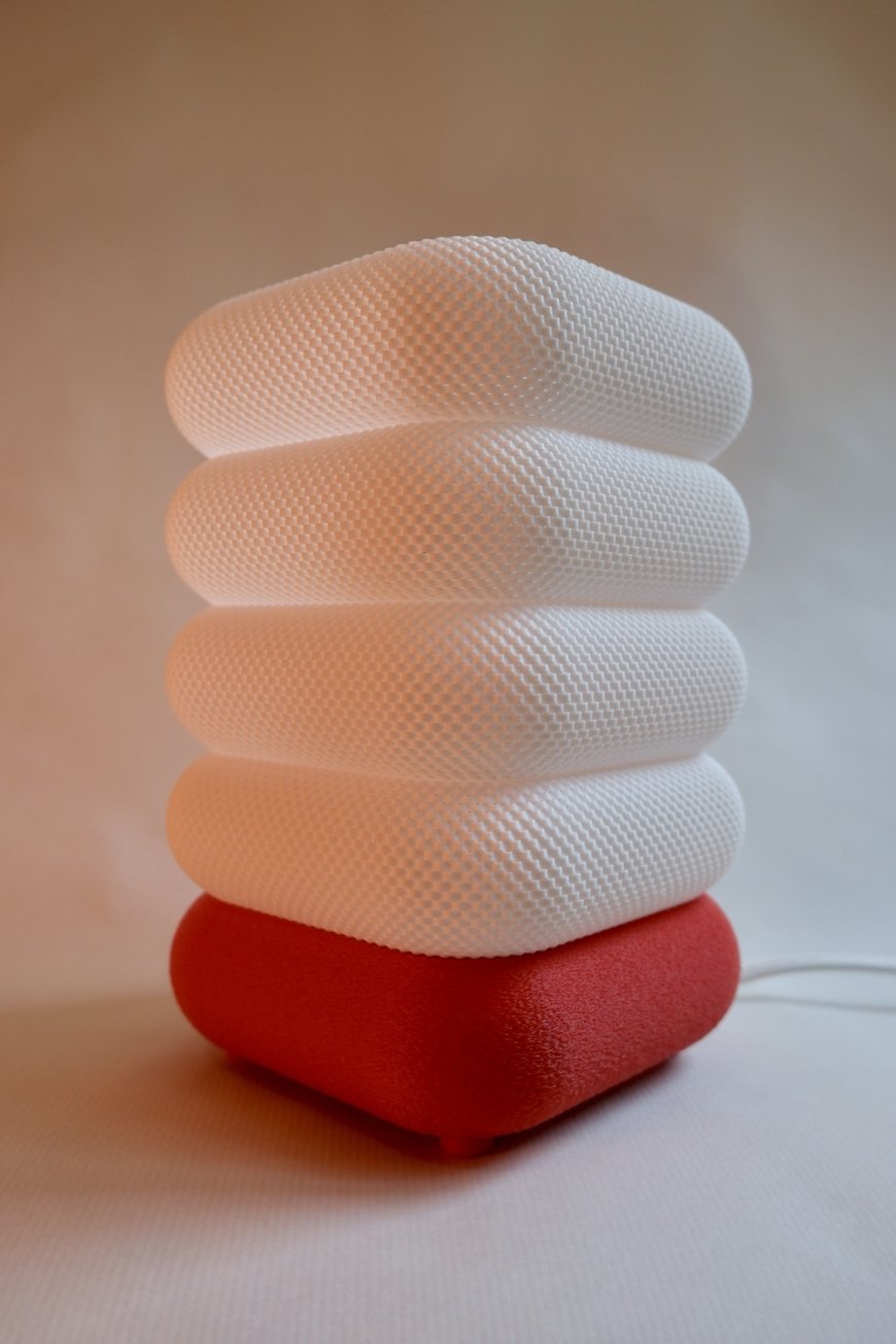 White Nobu3D lamp with red base in daylight